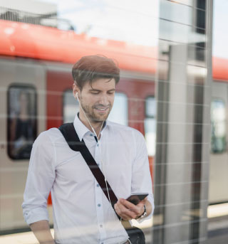 Man by Train on Phone